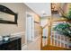 Welcoming foyer featuring traditional wainscoting, staircase, and decorative mirror at 1389 Chatfield Pl, Orlando, FL 32814