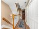 Hallway featuring hardwood floors and a staircase with white railings at 1389 Chatfield Pl, Orlando, FL 32814