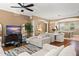 Living room flows into the dining and kitchen areas with neutral colored sofas and tv at 1389 Chatfield Pl, Orlando, FL 32814