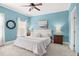 This main bedroom features blue walls, carpet flooring, and a ceiling fan at 1389 Chatfield Pl, Orlando, FL 32814