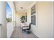 Inviting outdoor seating area featuring a loveseat, accent table, and large windows at 1389 Chatfield Pl, Orlando, FL 32814