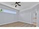 Serene bedroom features hardwood floors, a sleek ceiling fan, and plenty of natural light at 1409 Golf Course Pkwy, Davenport, FL 33837