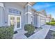 Close up on the front entrance of a home, featuring a double door and adjacent garage at 1409 Golf Course Pkwy, Davenport, FL 33837