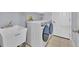 Functional laundry room with modern washer/dryer and utility sink at 1409 Golf Course Pkwy, Davenport, FL 33837