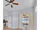 Bright living room featuring a ceiling fan, hardwood floors, and large sliding doors to the outdoor living area at 1409 Golf Course Pkwy, Davenport, FL 33837