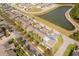 Aerial view of townhomes near a pond and lush greenery, showcasing community layout and natural surroundings at 14849 Driftwater Dr, Winter Garden, FL 34787