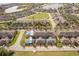 Aerial view of townhomes near a pond and lush greenery, showcasing community layout and natural surroundings at 14849 Driftwater Dr, Winter Garden, FL 34787