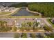 Aerial view of townhomes near a pond and lush greenery, showcasing community layout and natural surroundings at 14849 Driftwater Dr, Winter Garden, FL 34787