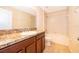 Well-lit bathroom featuring granite counters, wood cabinets, tile flooring, and a shower-tub combination at 14849 Driftwater Dr, Winter Garden, FL 34787