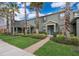 Beautiful townhome with a well-manicured lawn, brick walkway, and vibrant landscaping with mature palm trees at 14849 Driftwater Dr, Winter Garden, FL 34787