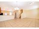 Open-concept living and dining area with ceramic tile flooring and a modern chandelier at 14849 Driftwater Dr, Winter Garden, FL 34787