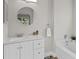 Bathroom featuring neutral walls, tiled floors, a white sink and vanity, and a bathtub with a showerhead at 14923 Day Lily Ct, Orlando, FL 32824