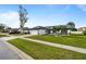 Lovely single-story home featuring manicured lawn and palm tree landscaping at 14923 Day Lily Ct, Orlando, FL 32824