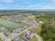 Aerial view of a home in a neighborhood, featuring a pool with screened enclosure at 2117 Trani Ter, St Cloud, FL 34771