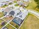 Aerial view of a house with a pool, screened enclosure, and solar panels at 2117 Trani Ter, St Cloud, FL 34771