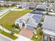 Aerial view of a home featuring brick driveway, landscaping, and solar panels at 2117 Trani Ter, St Cloud, FL 34771