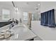 Well-lit bathroom showcasing a stylish sink, vanity, and glass shower at 2117 Trani Ter, St Cloud, FL 34771