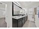 Spacious bathroom featuring a large mirror, double sinks, and dark cabinetry at 2117 Trani Ter, St Cloud, FL 34771