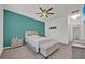 Inviting bedroom with a teal accent wall, comfortable bed, and neutral decor at 2117 Trani Ter, St Cloud, FL 34771