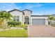 Beautiful single-story home with a well-manicured lawn, brick driveway and attached two car garage at 2117 Trani Ter, St Cloud, FL 34771