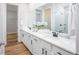 Bathroom featuring double vanity with marble countertop and white cabinets across from subway tile shower at 2218 Elegant Maor Cir, Edgewater, FL 32141