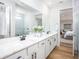 Double sink bathroom with marble counter tops, white cabinets, and subway tile shower at 2218 Elegant Maor Cir, Edgewater, FL 32141