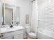 Bathroom featuring white cabinets, subway tile shower, and framed artwork at 2218 Elegant Maor Cir, Edgewater, FL 32141