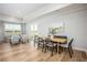 Bright dining area with wood floors, farmhouse style table, and bench seating at 2218 Elegant Maor Cir, Edgewater, FL 32141