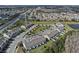 An aerial view of the neighborhood showcasing townhomes, a streetscape, landscaping, and the surrounding community at 2258 Sedge Grass Way, Orlando, FL 32824