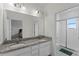 Bathroom with double granite vanity and glass-enclosed shower at 2258 Sedge Grass Way, Orlando, FL 32824