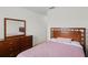 Bedroom with wood bed frame, dresser, and mirror at 2258 Sedge Grass Way, Orlando, FL 32824