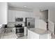 Stylish kitchen featuring stainless steel appliances, white cabinetry and a granite-topped island at 2258 Sedge Grass Way, Orlando, FL 32824