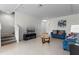 Living room with tile floors, stairs to the second floor and comfortable seating at 2258 Sedge Grass Way, Orlando, FL 32824