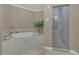 Bright bathroom with a soaking tub and glass shower at 2305 Edgewater Dr # 1701, Orlando, FL 32804