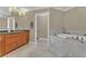 Bright bathroom featuring granite countertops and a soaking tub at 2305 Edgewater Dr # 1701, Orlando, FL 32804