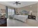 Spacious bedroom with a king bed, sitting area, and ceiling fan at 2305 Edgewater Dr # 1701, Orlando, FL 32804