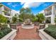 Outdoor courtyard featuring lush landscaping, benches, and a decorative fountain at 2305 Edgewater Dr # 1701, Orlando, FL 32804