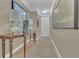 Stylish hallway featuring neutral-colored walls, tile flooring, and an elegant console table with lamps at 2305 Edgewater Dr # 1701, Orlando, FL 32804