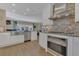 Well-lit kitchen with modern appliances, stainless steel sink, and a view to the living room area at 2305 Edgewater Dr # 1701, Orlando, FL 32804