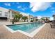 Community pool area with lounge chairs, palm trees, and manicured landscape at 2305 Edgewater Dr # 1701, Orlando, FL 32804