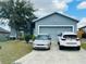 Charming two-story home with a two-car garage and a well-maintained front yard and driveway at 233 Ashley Loop, Davenport, FL 33837