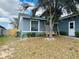 Cozy home featuring a cozy porch swing and a well-manicured lawn with decorative landscaping at 233 Ashley Loop, Davenport, FL 33837