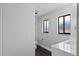 Modern bathroom featuring a sleek vanity, two windows for natural light, and a toilet at 2335 Montano St, Deltona, FL 32738