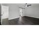 The bedroom boasts wood floors, a ceiling fan, and a modern barn door leading to the bathroom at 2335 Montano St, Deltona, FL 32738