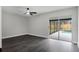 Light-filled bedroom with dark hardwood floors, ceiling fan, and sliding glass doors leading to the outdoor patio at 2335 Montano St, Deltona, FL 32738