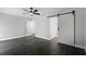 Bedroom showcasing wood flooring, a ceiling fan, and a sliding barn door leading to an additional space at 2335 Montano St, Deltona, FL 32738