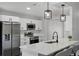 Eat-in kitchen featuring quartz counters, stainless appliances, and modern pendant lighting at 2335 Montano St, Deltona, FL 32738