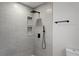 The modern shower is equipped with rainfall shower head, handheld wand, and built-in shelving at 2335 Montano St, Deltona, FL 32738