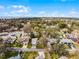 Beautiful aerial view of a home in a tree-lined neighborhood, showcasing its serene setting and curb appeal at 250 Douglas Dr, Eustis, FL 32726