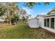 Exterior view of a well-maintained backyard with green grass and a shed, ideal for storage and outdoor activities at 250 Douglas Dr, Eustis, FL 32726